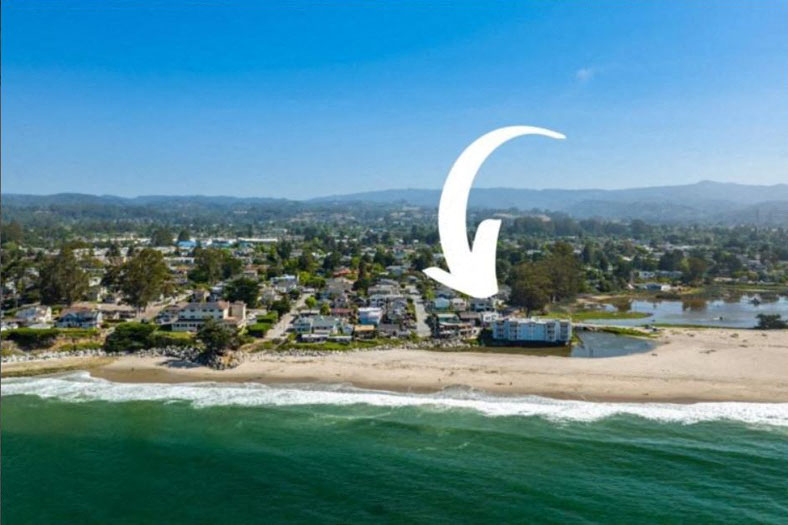 A beachfront community with a clear blue sky overhead.